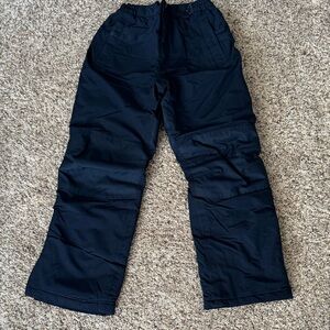 Unworn, dark blue, kids ski pants. Elastic waist and ankles.
